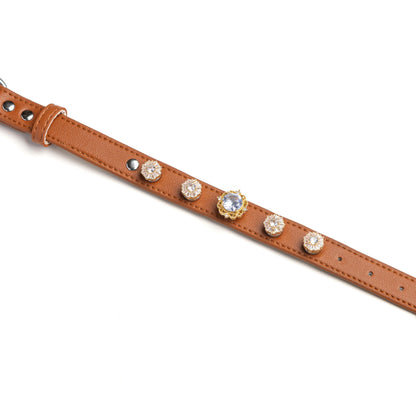 Brown dog collar with snowflake crystal and diamond-center charms by Vanderclix&Co., detail view.