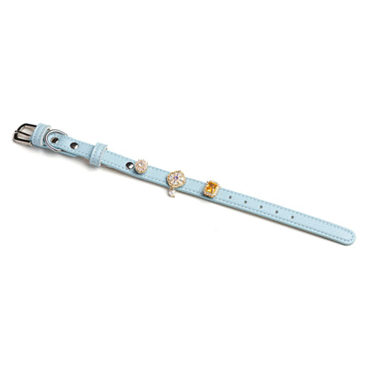 Charmed snap-on crystal gem set on Tidal blue leather collar by Vanderclix&Co., angled view.