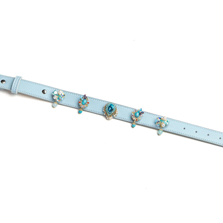 Blue dog collar with layered decorative gem charms by Vanderclix, detail view.